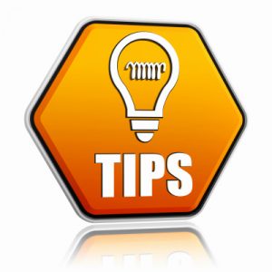 tips and bulb symbol in orange hexagon banner