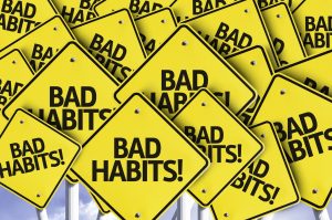 Bad Habits! written on multiple road sign