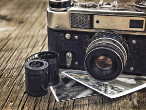 old vintage camera closeup on wooden background