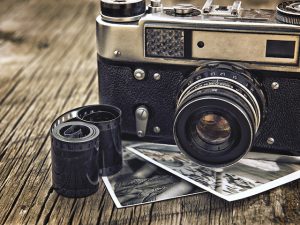 old vintage camera closeup on wooden background